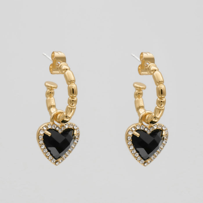 Gold hoop earrings with black heart pendants.