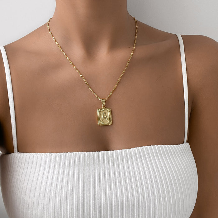 model wearing classic initial necklace in 18k gold plated from prya