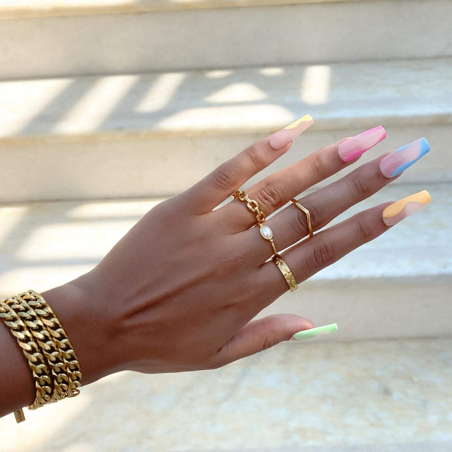 Model wearing a range of rings including birthstone ring