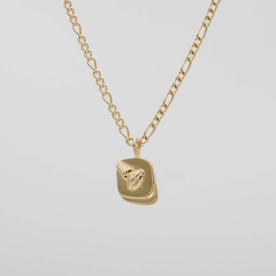 Gold chain with a textured rectangular pendant.