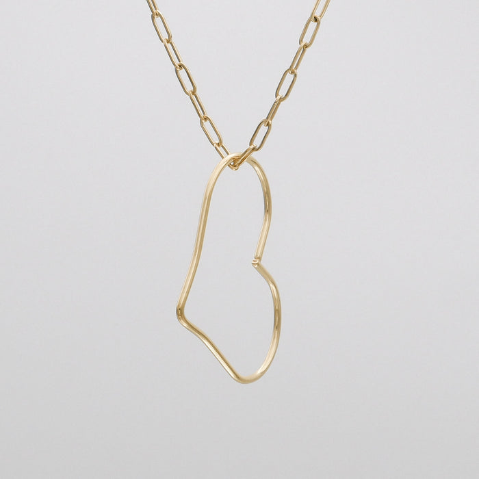 Gold abstract heart necklace on chain.