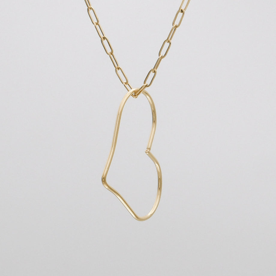 Gold abstract heart necklace on chain.