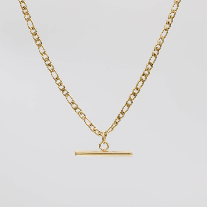 Gold chain necklace with bar pendant.