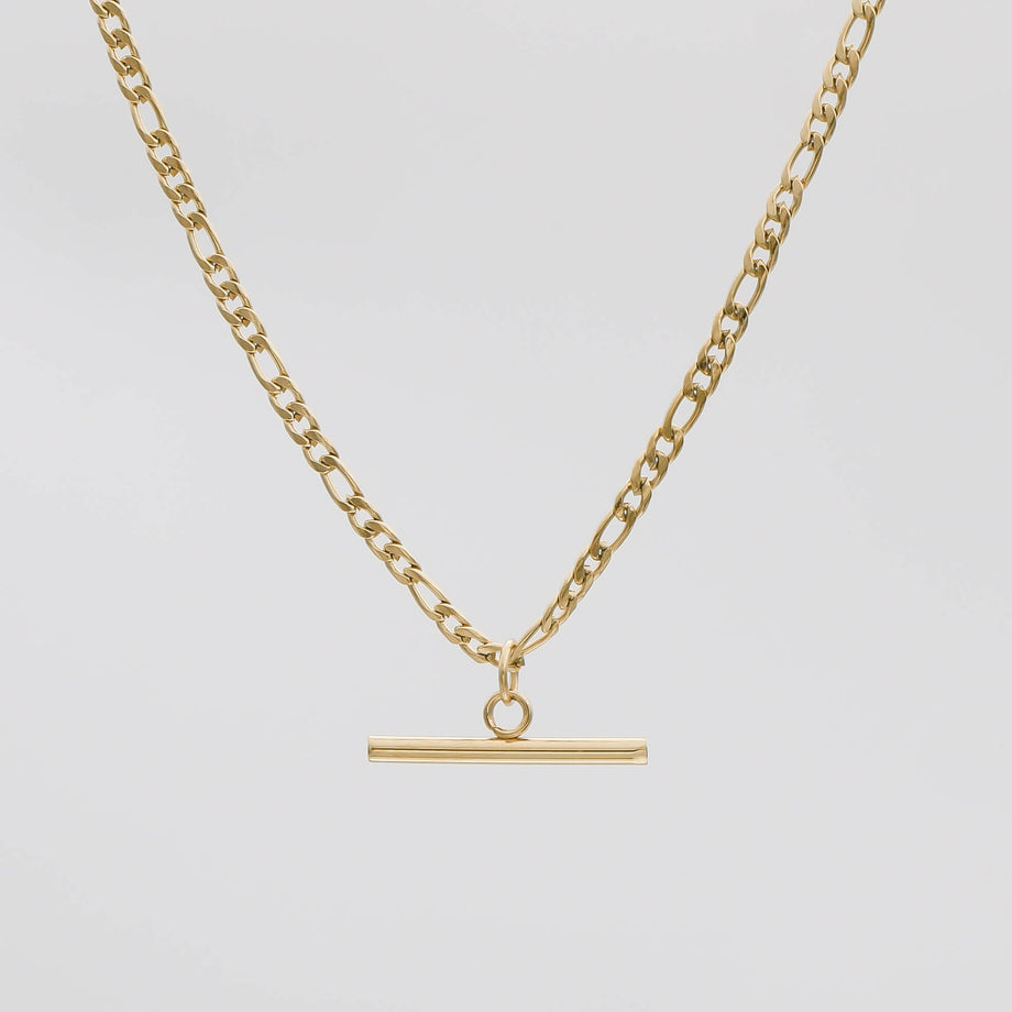 Gold chain necklace with bar pendant.