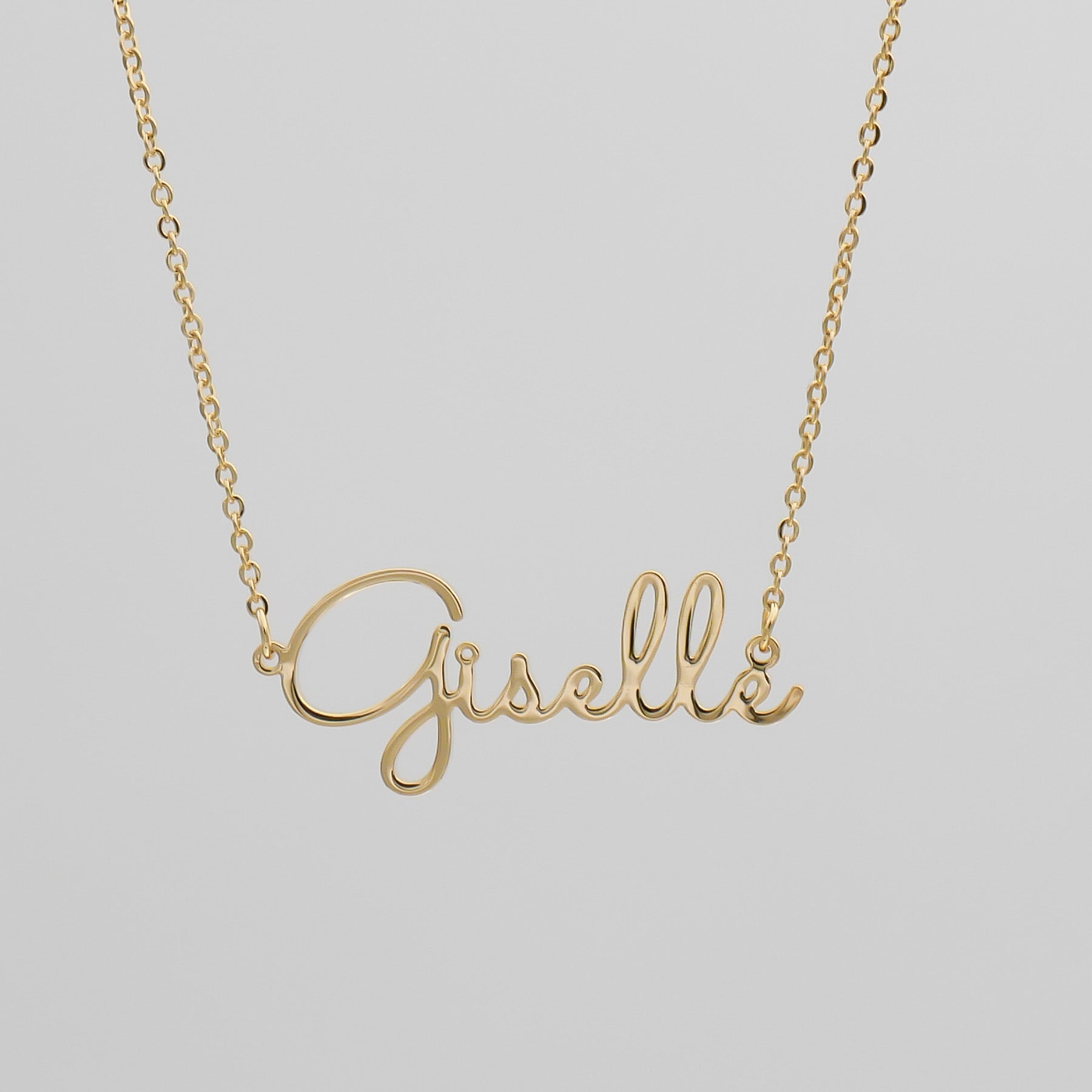 Gold name necklace that says Giselle 