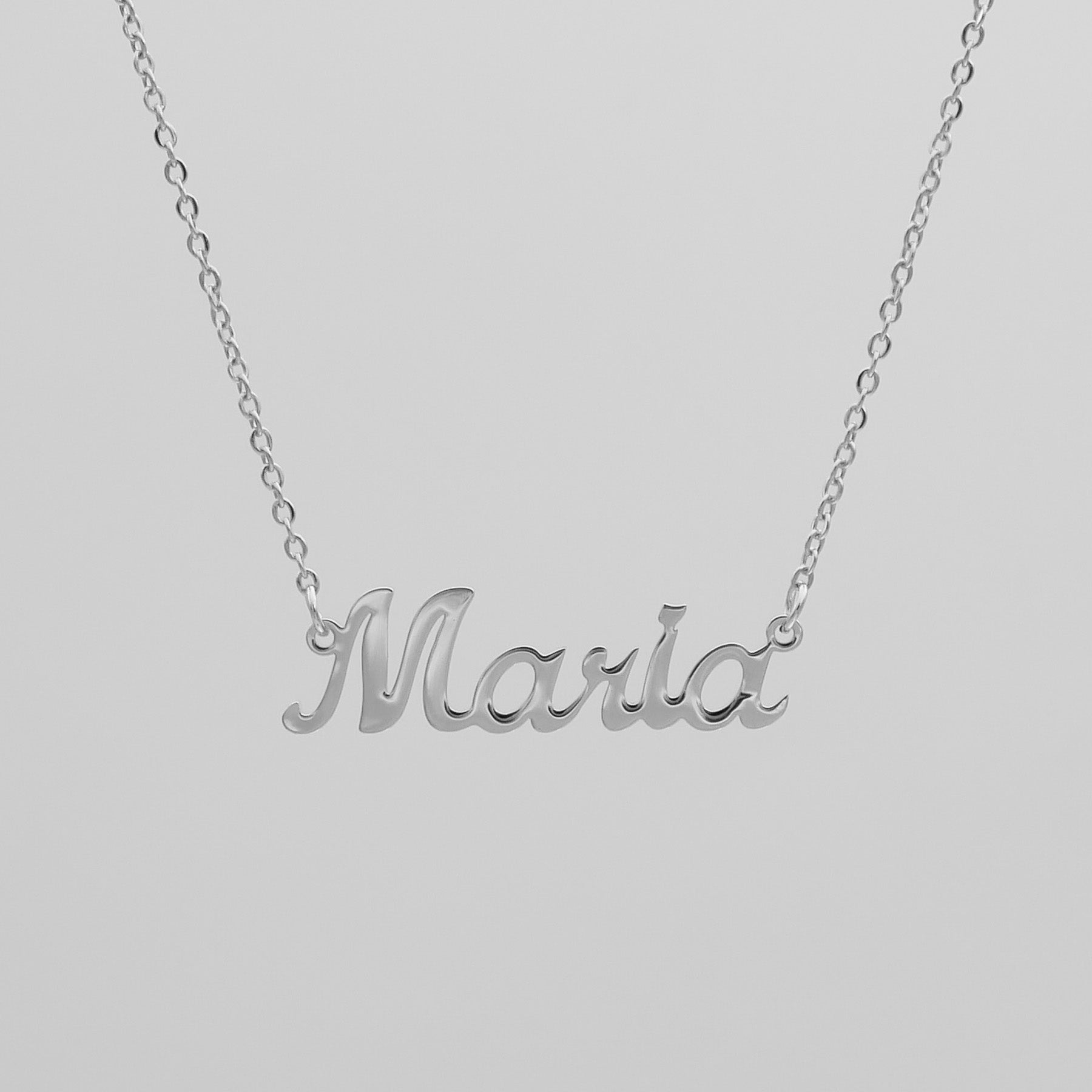 Silver custom name necklace suspended in the air