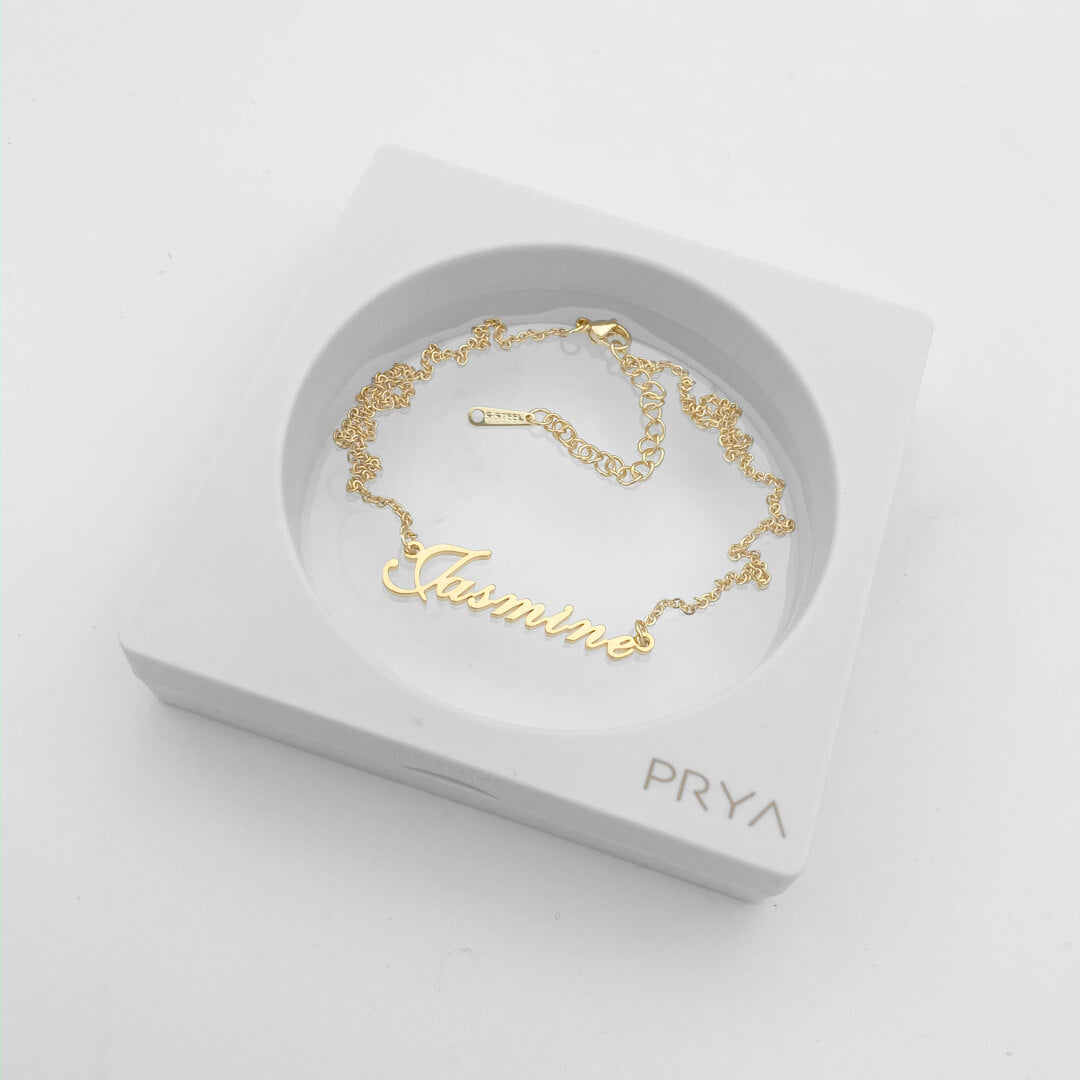 Gold Siena personalised name necklace in a display case