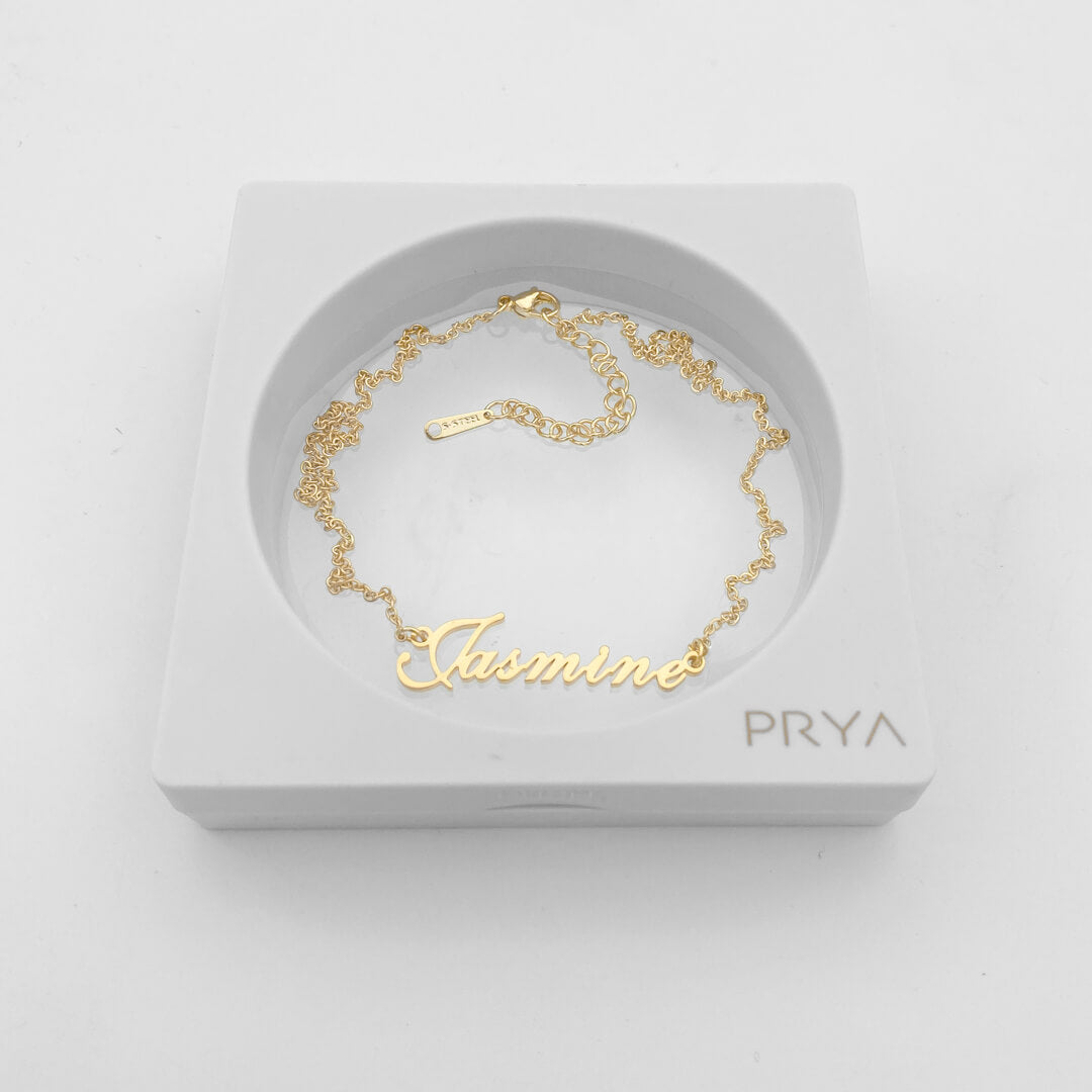 Gold personalised name necklace in a display case