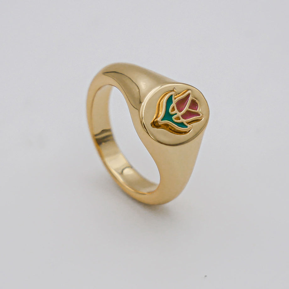 Gold ring with colourful bird design.