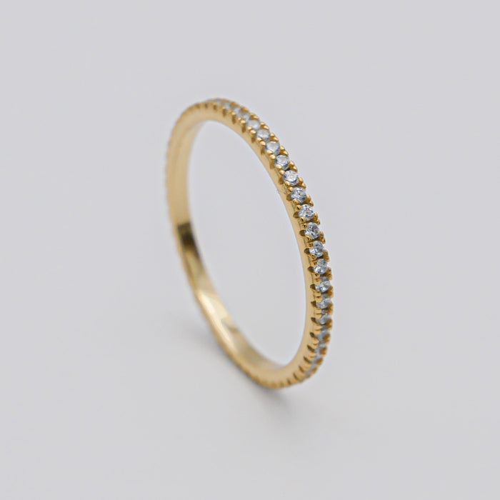 Gold ring with small diamonds in a circle.