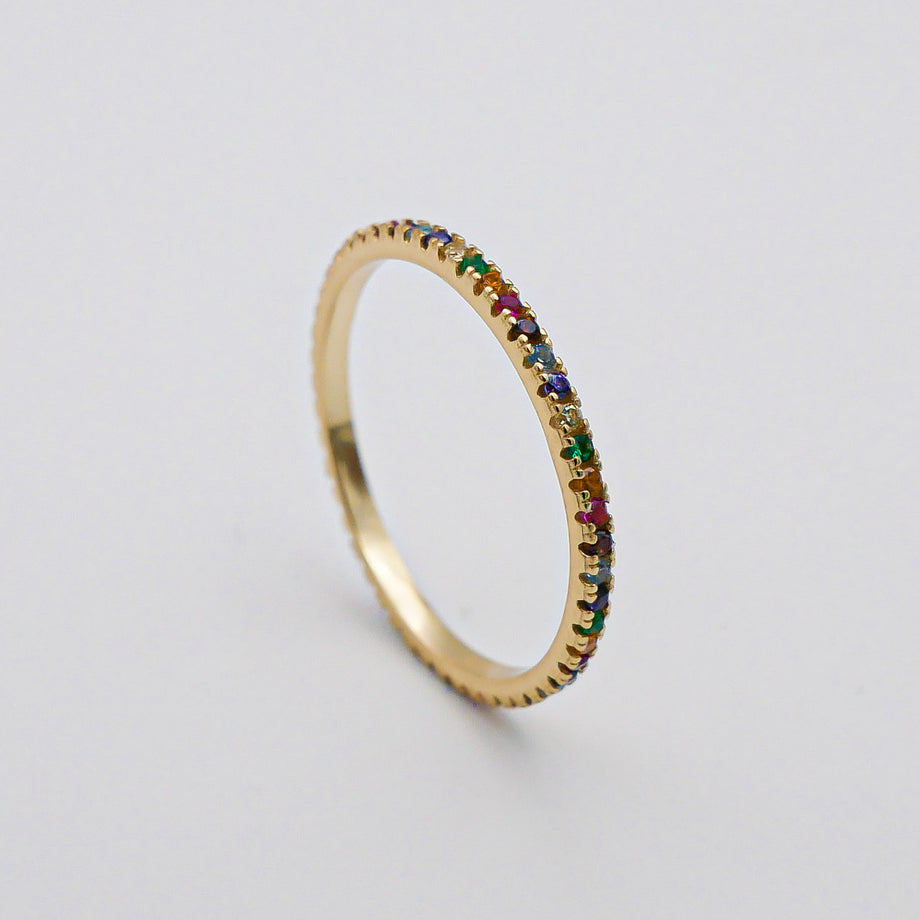 Gold ring with colourful gemstones.