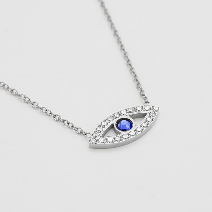 close up of silver evil eye necklace with  paved cz stones and blue stone centre