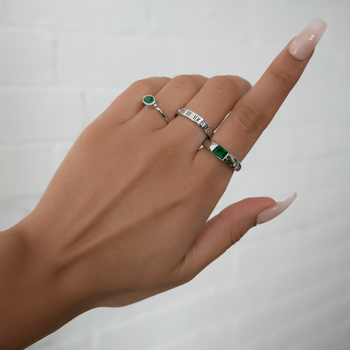 model wearing birthstone ring in silver and ring stacks from prya