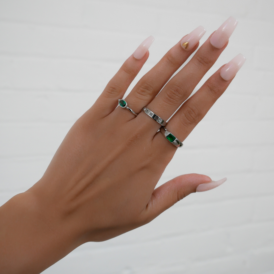 model wearing birthstone ring in silver and ring stacks from prya