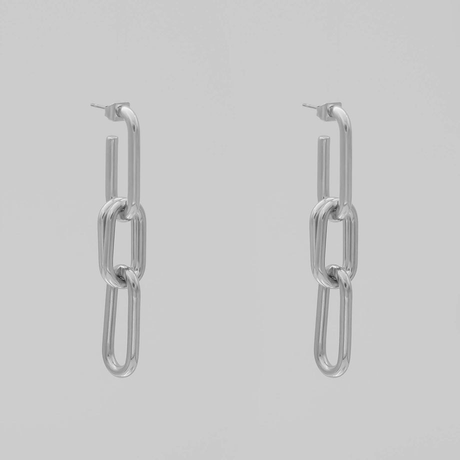silver chain adjustable link earrings with three links on grey background.