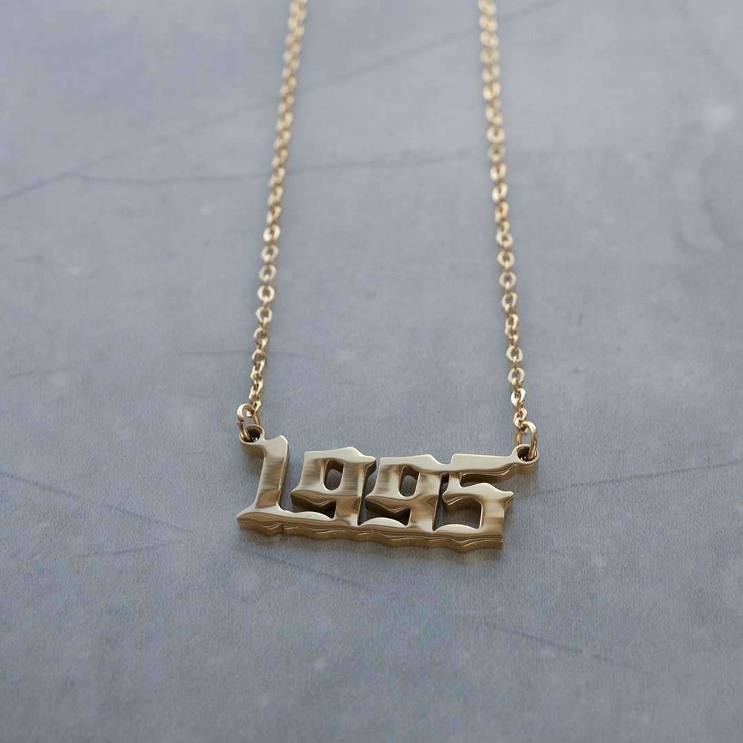 1995 birth year necklace laid flat on surface