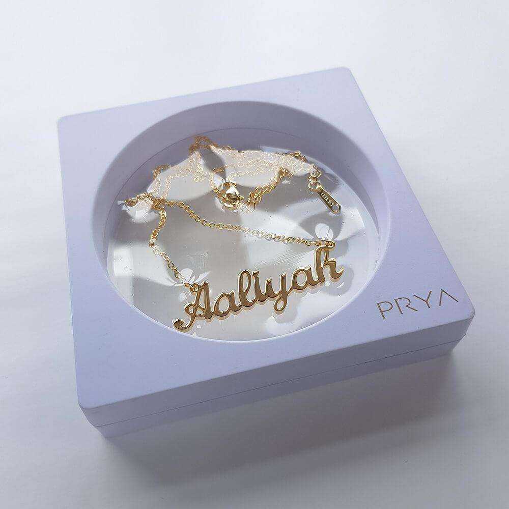 Gold custom name necklace in display box
