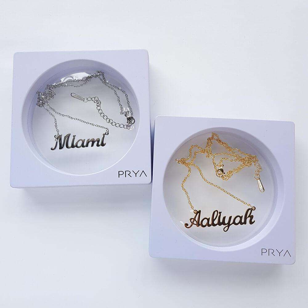 Silver and gold custom name necklaces in boxes